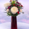 Striking and sophisticated, Crimson Elegance features lush white spider mums and soft