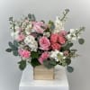 Pink and white floral arrangement in a wooden box