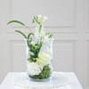White floral arrangement in a clear glass vase