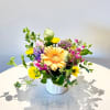 A joyful, garden-inspired arrangement bursting with color and texture. Featuring a radiant