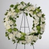 A beautiful white and green tribute wreath that calms, this easel arrangement