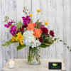 Sure to cause a stir, this modern arrangement of bright blooms includes