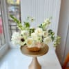 A fresh, garden-style flower basket filled with creamy white roses, seasonal blooms