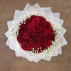 Bouquet of red roses with white baby's breath in white wrap