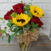 Sunny sunflowers with gorgeous red roses sure to romance her!
