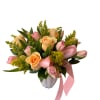 Peach roses, pink tulips and yellow aster designed round faced in a