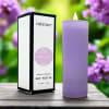 Lavender soy votive candle beside its box