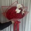 Large bouquet of red roses with white orchids wrapped in red paper
