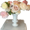 Soft blush, cream, and pale peach roses mingle with a few white
