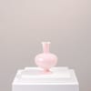 Pink glass vase on a white pedestal