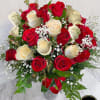 Tall vase arrangement of red and cream roses with baby's breath and a red ribbon