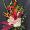 A bold and vibrant tropical arrangement featuring striking heliconia and ginger blooms