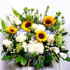 Mixed bouquet with sunflowers, white roses, and blue hydrangeas in a rectangular container
