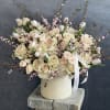 A soft and elegant blush flower arrangement featuring delicate shades of pale