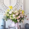 Pic shown as deluxe size. Features Blushes roses, ranunculus, sweet peas with