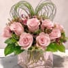 
This elegant floral arrangement features a compact cluster of rich red roses