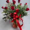 Deep, romantic red roses arranged in a light, hand-tied style make a
