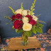 Bouquet of red and white roses in a clear glass vase