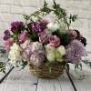 Basket arrangement of pink, white, and purple flowers