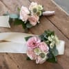 Pink prom corsage featuring fresh seasonal blooms, handcrafted for a romantic and