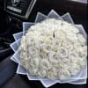 Bouquet of white roses wrapped in translucent paper