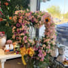 A large heart-shaped standing wreath that reads as tender and hopeful -