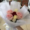 A rounded hand-tied rose bouquet that reads like a sweet kiss-perfect as