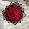 Bouquet of red roses wrapped in black paper