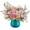 this quaint blue vase is filled with hues of pinks greens and