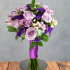 Lavender roses mingle with pink-and-white alstroemeria in this purple prom bouquet, a