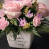 A soft and elegant arrangement featuring blush pink roses, carnations, and lavender