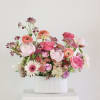 Pink and peach mixed flowers in a white ribbed vase