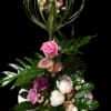 A dramatic vertical arrangement of pink and white roses and calla lilies