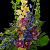 A tall, dramatic tropical-style flower arrangement that greets the room with bold