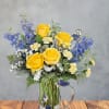 Bright yellow roses form the sunny heart of this flower arrangement, making