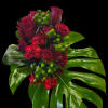 Deep, velvety red roses and clustered red carnations create an immediate, romantic