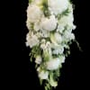 Cascading layers of white roses, calla lilies, orchids and hydrangeas create a