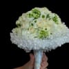 A compact, rounded hand-tied bouquet that reads bridal and timeless-white and cream
