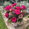 Twelve gorgeous hot pink roses accented with brown lisianthus, burgundy amaranth, and