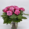 Pink roses arranged in a clear glass vase