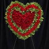 Heart-shaped red rose and carnation standing spray on an easel