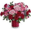 Red and pink rose bouquet in a red vase