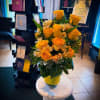 A cheerful burst of golden yellow roses paired with soft accent blooms