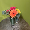 Send this fun arrangement of bright flowers in a beer mug to