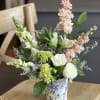 Soft, garden-fresh and slightly romantic, this flower arrangement is a peach, white