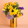 Bright yellow roses and lilies catch the eye first in this celebratory