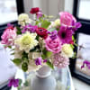 A lovely flower arrangement of premium blooms in shades of pink and