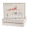 Stacked boxes of farmstead goat milk caramels with illustrated goats and a red barn