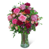 Pink and magenta rose bouquet in a clear glass vase