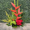 A modern style arrangement in orange, red, green and yellow consisting of
